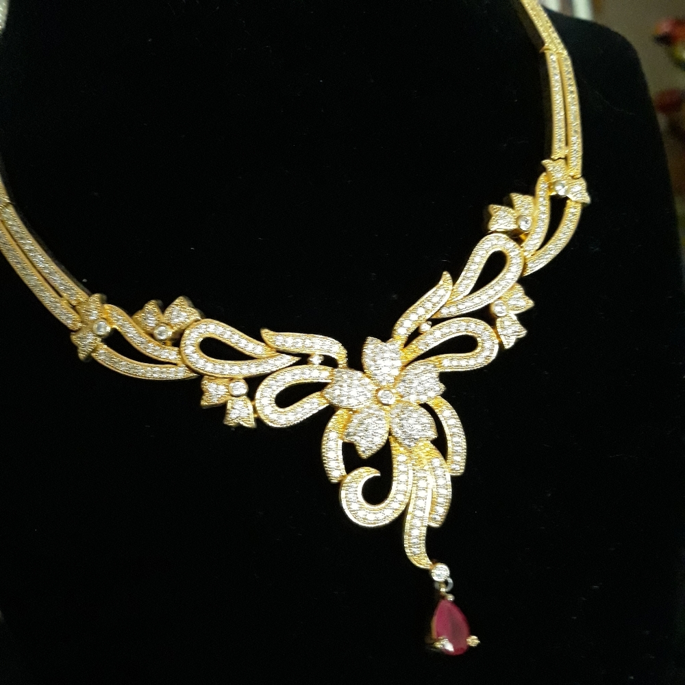 Necklace, earrings.